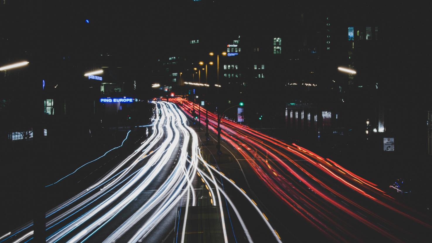 two way street with car lights going each direction