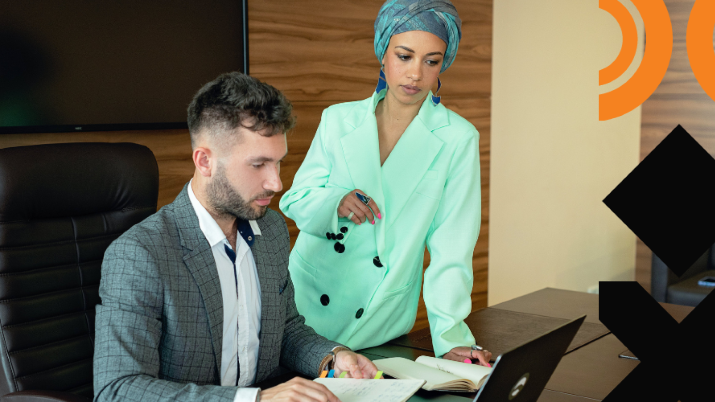 two coworkers working at a desk together