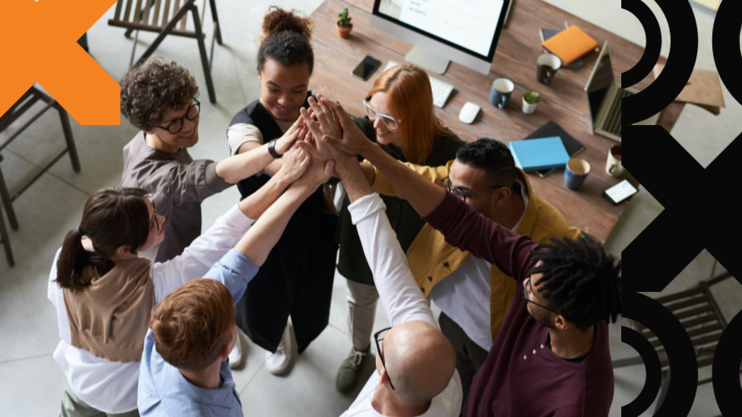 Teammates highfiving overhead in an office