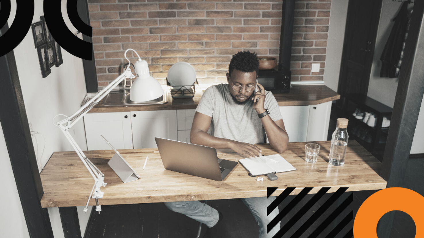 Man at desk working and talking on the phone