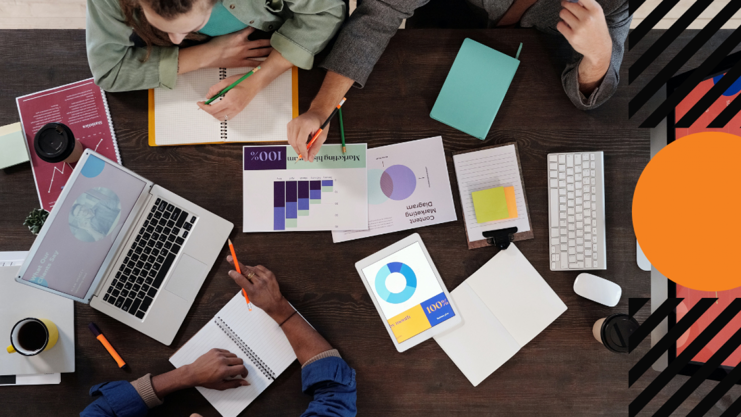 Group of people working together collaborating on analytical documents