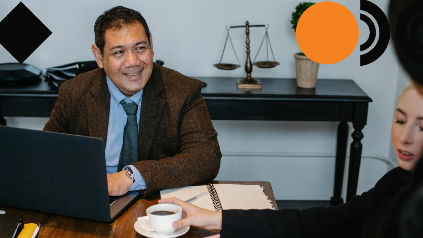 man smiling at his desk 