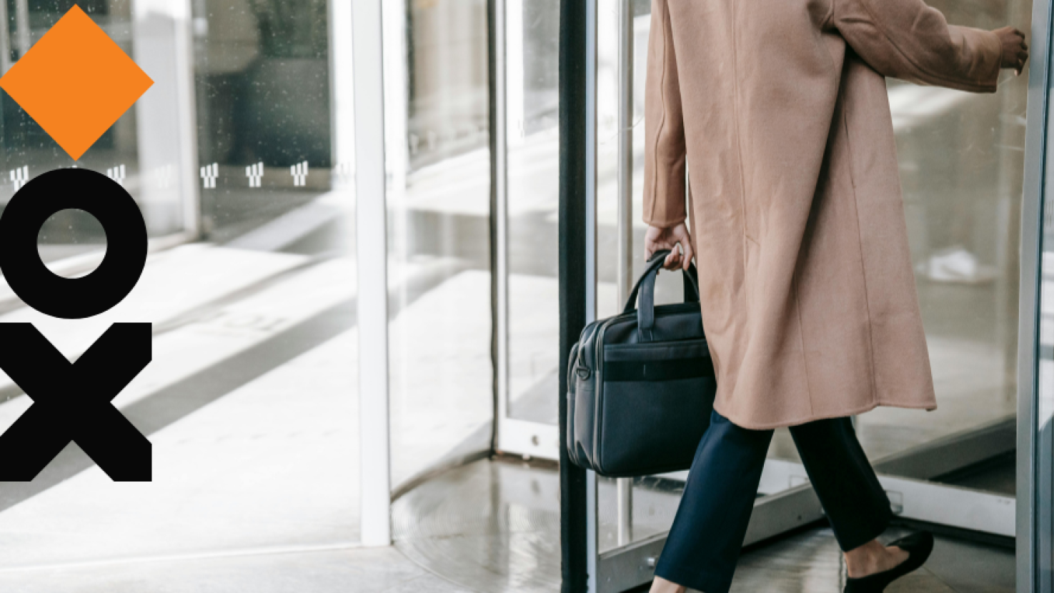 Woman walking into a building with a briefcase